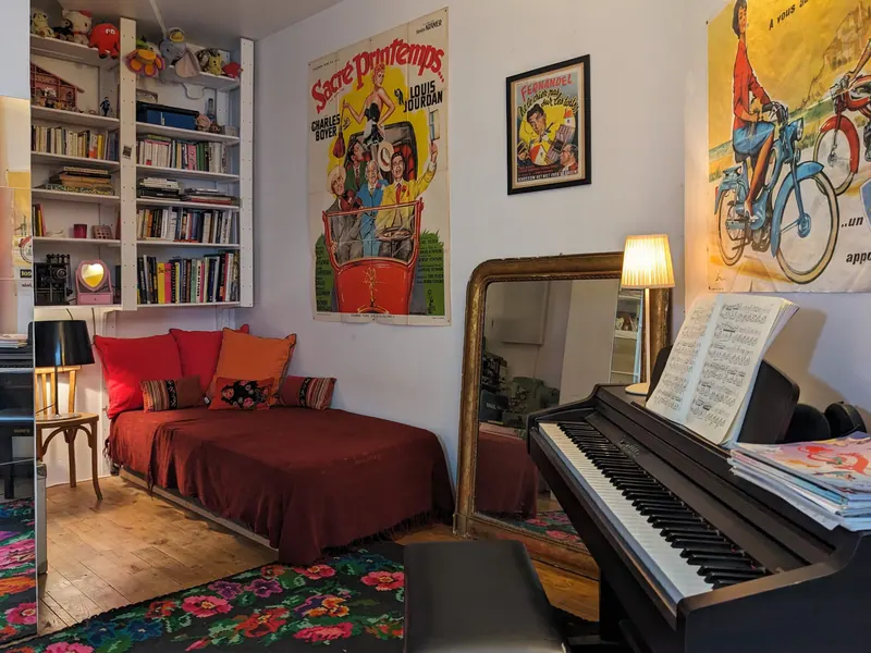 Office or 4th bedroom: red daybed, bookcase and piano
