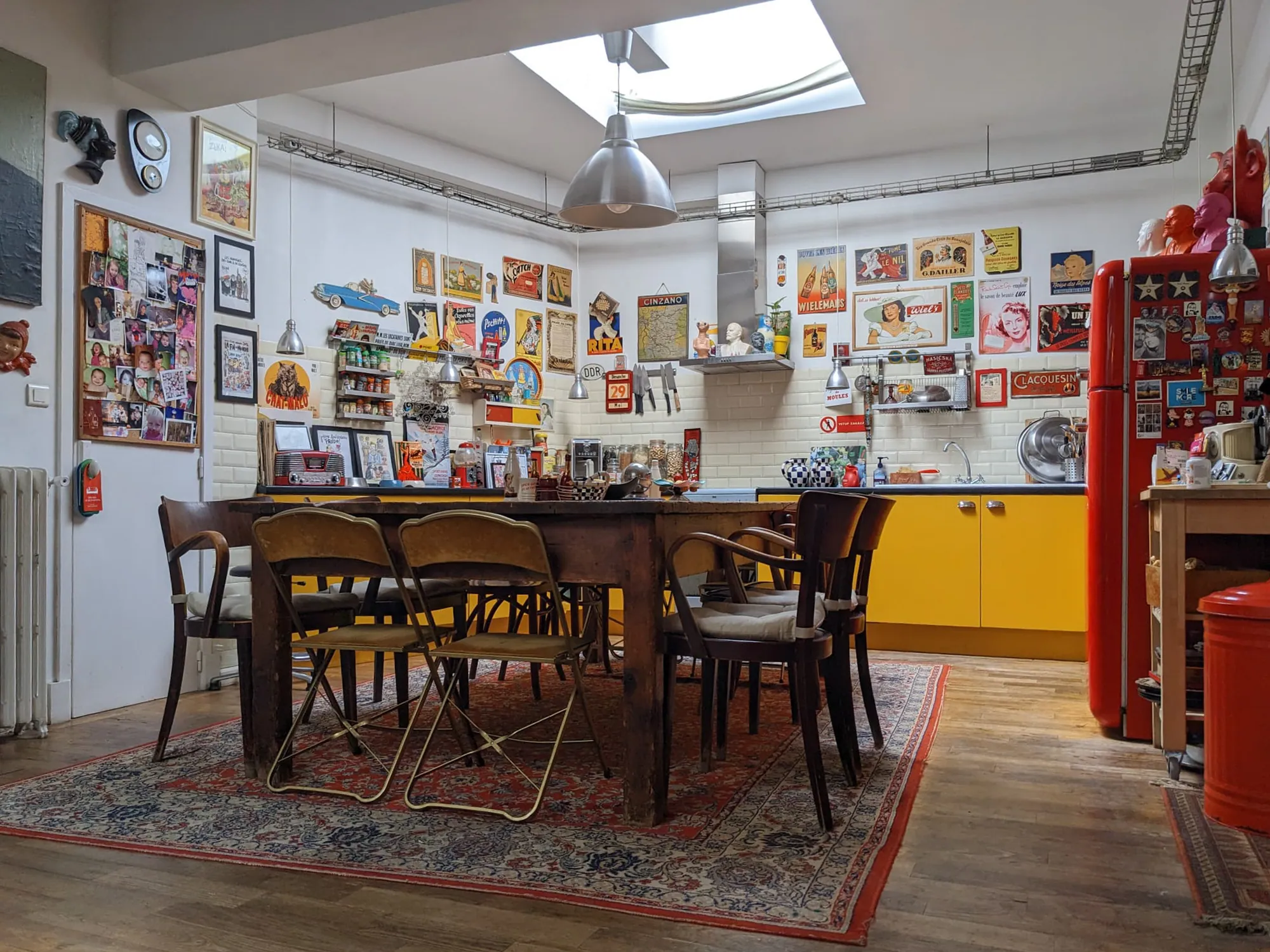 Yellow kitchen and large dining table under the skylight