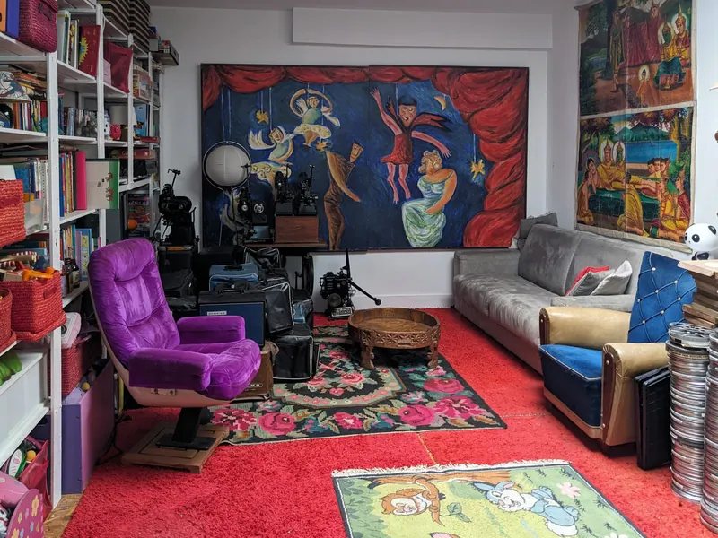 The large bedroom: big mural, bookcase and sofa