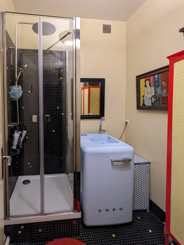 Shower room with shower cabin and black tiles